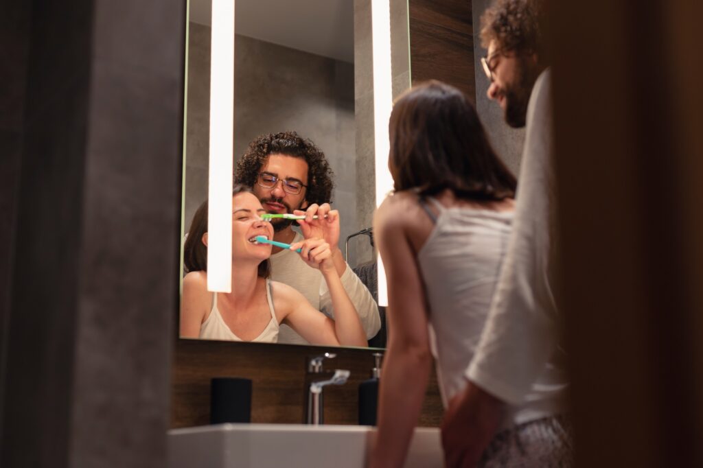 Couple brushing teeth before bedtime