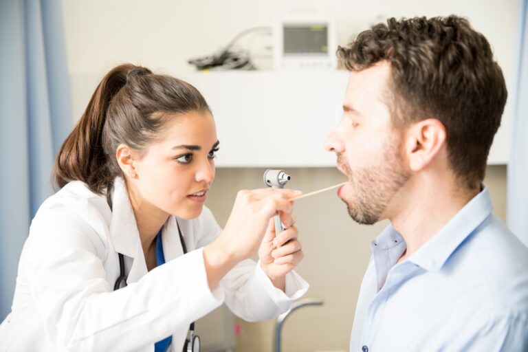 Ophthalmologist examining sore throat of a patient